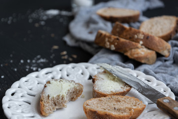 Whole oat sliced bread and fresh butter. Healthy eating concept