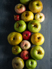 rows of apples on dark background