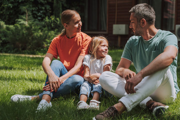 Parents spending time with their daughter outdoors