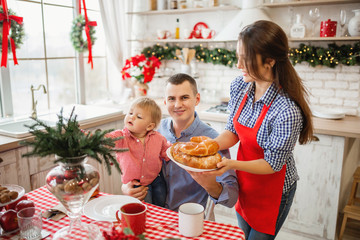Family preparing Christmas meal in kitchen