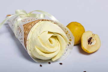 Waffle cone filled with quince marshmallows. Decorated for a gift. Nearby are the fruits of quince.