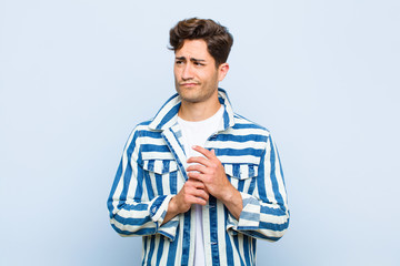 young handsome man scheming and conspiring, thinking devious tricks and cheats, cunning and...