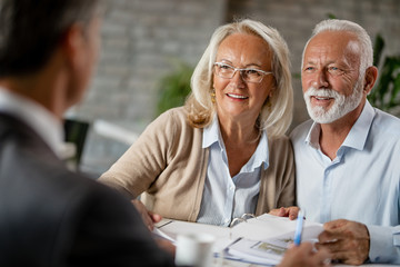 Happy senior couple having a meeting with real estate agent. - obrazy, fototapety, plakaty