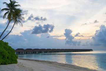 Fototapeta premium Wooden bridges leading to the huts on the shores of the tropical