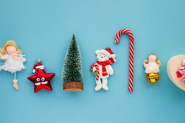 Christmas composition. Beautiful toys, gifts and candy on the blue background. New year background. Top view. Close up. Space for a text.