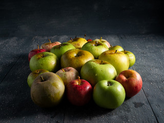 different apples on wooden table