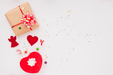Christmas composition. Beautiful toys, gifts and candy on the white background. New year background. Top view. Close up. Space for a text.