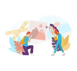 Female and male photographer standing and holding camera and shooting.