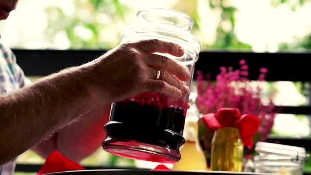 hand prepare homemade juice and cover jar on the balcony, 120fps