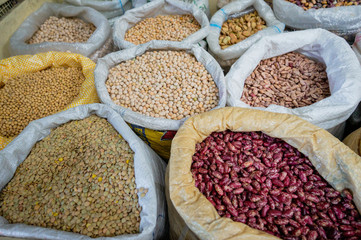Different kinds of healty grains, legumes and beans in bulk bags at the market in Ibarra, Ecuador, South America. Organic healthy fresh vegan food.