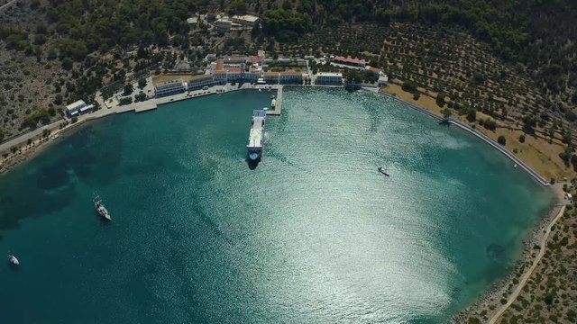 Aerial drone video of iconic old windmills of Symi island at sunset with beautiful scattered clouds, Symi island, Dodecanese, Greece.