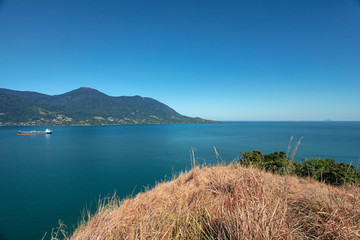 Beautiful panoramic view of Ilhabela island and coast of Sao Sebastiao, tropical island on the Brazilian sea coast during a sunny day of vacation and sightseeing.