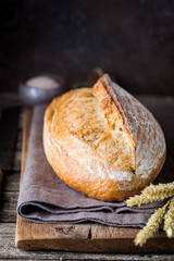 Freshly baked homemade traditional bread on rustic wooden table