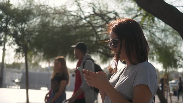 Portrait of a girl using the voice recognition of the phone and looking at cell phone near hotel on vacation tourist speech personal assistant natural language user interface audio