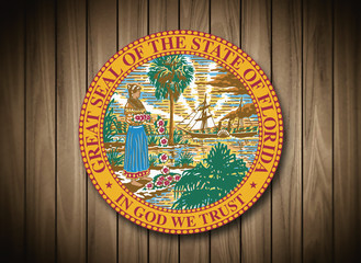 Florida coat of arms on wooden background.