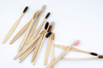 Top view Set with bamboo wooden toothbrushes on white background. Zero waste and plastic free
