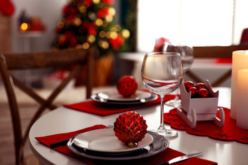 Naklejka na ściany i meble Festive table setting and Christmas tree in stylish room interior