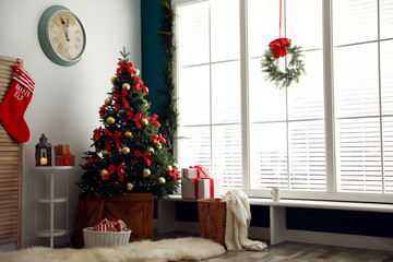 Stylish room interior with decorated Christmas tree