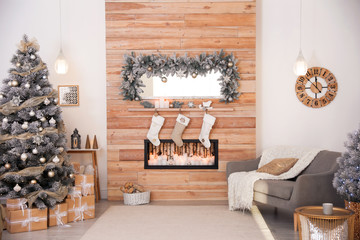 Beautiful Christmas interior of living room with decorative fireplace
