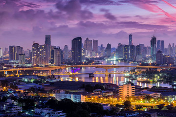 Fototapeta premium Bangkok city and Chao Phraya River at sunset in business district, Bangkok,Thailand. Bangkok is the capital and most populous city of Thailand. 