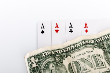 Four aces, playing cards and dollar.