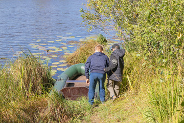 Children prepare an inflatable boat for launching