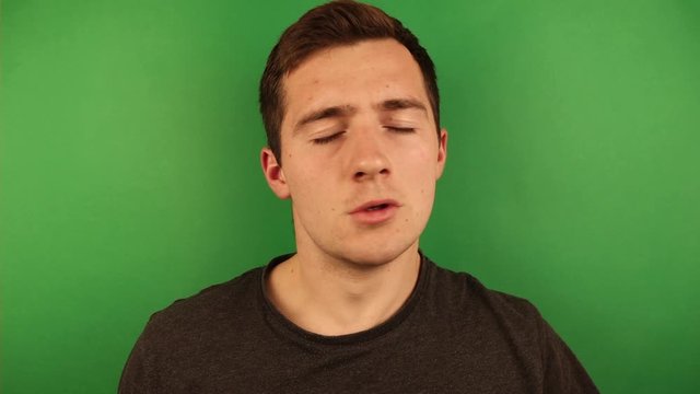 a man tries to recover on a green background