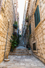 Fototapeta na wymiar Dubrovnik, Croatia - July, 2019: Picturesque narrow street in Dubrovnik, Croatia. Dubrovnik joined the UNESCO list of World Heritage Sites