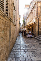 Fototapeta na wymiar Dubrovnik, Croatia - July, 2019: Picturesque narrow street in Dubrovnik, Croatia. Dubrovnik joined the UNESCO list of World Heritage Sites