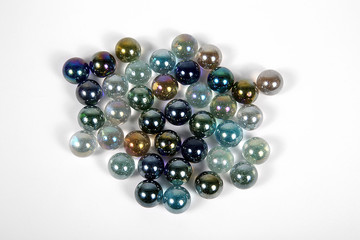 Colored glass bullets on white ground isolated