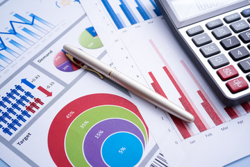 Business and finance with analytical study on market trend or demand with document on paper, calculator, and a pen