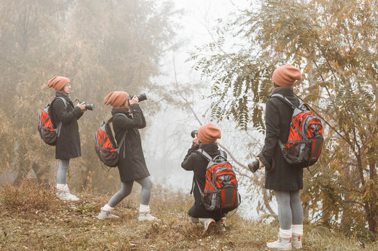 Girl photographer takes pictures of autumn nature. 