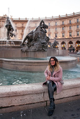 A girl posing for a photo near the Fontana delle Naiadi in Rome, Italy 
