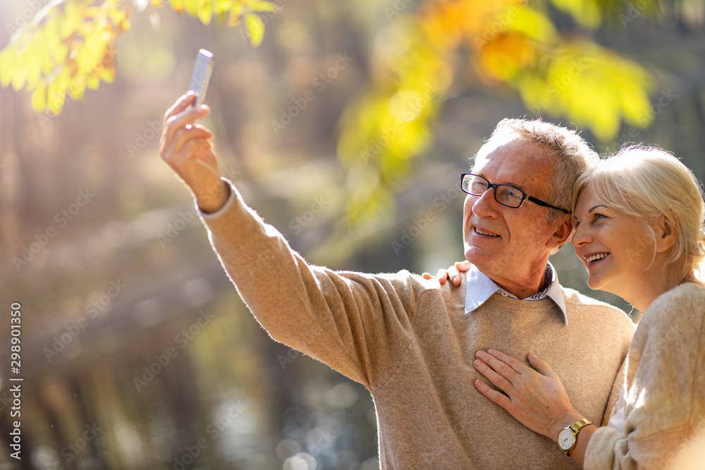 Canvas Prints senior couple taking selfie with smartphone in park