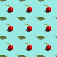 Seamless background with hot red pepper round with green leaf on blue background. Modern style isometric concept.