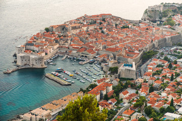 Fototapeta na wymiar Dubrovnik, Croatia - July, 2019: View from the top of the mountain of Srdj to the old part of the city in the fortress in Dubrovnik, Croatia.