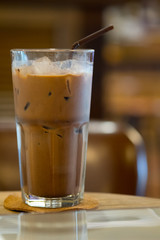 Iced Mocha coffee in glass on the wooden table