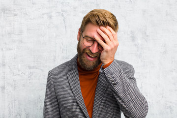 laughing and slapping forehead like saying d‚Äôoh! I forgot or that was a stupid mistake