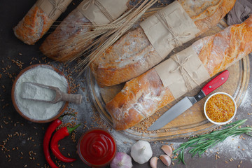 Bread in a composition with kitchen accessories on an old background
