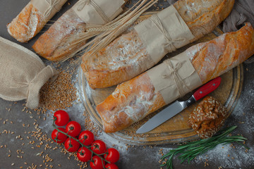 Bread in a composition with kitchen accessories on an old background