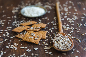 wheat crackers shooted with different  vegetables,groats,honey,seeds,salt on different surfaces