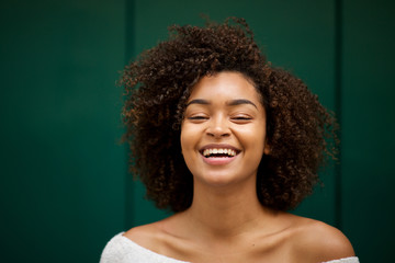Close up front of young smiling african american woman with curly hair