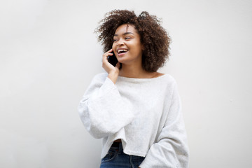 happy african american woman talking with mobile phone by white background - Powered by Adobe