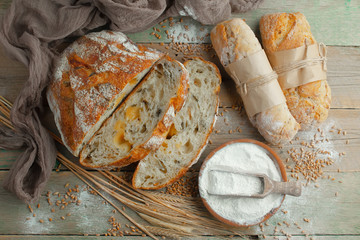 Bread in a composition with kitchen accessories on an old background