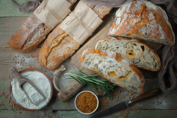 Bread in a composition with kitchen accessories on an old background