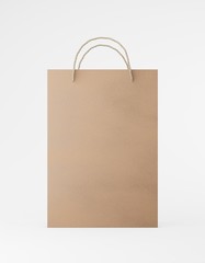 Eco packaging mockup bag kraft paper with handle front side. Standard medium brown template on white background promotional advertising. 3D rendering
