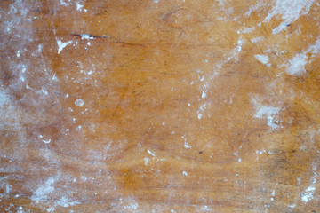 Old cutting board sprinkled with flour. Tools for cooking. Wood background.