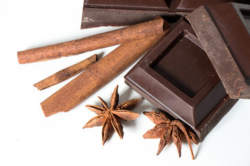 Pieces of Chocolate and cinnamon isolated on white background