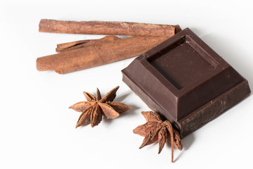 Pieces of Chocolate and cinnamon isolated on white background