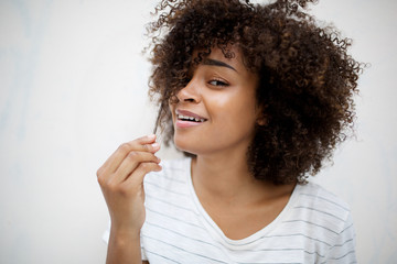 smiling young african american woman pulling hair